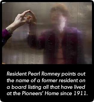 This is a picture Resident Pearl Romney pointing at a memorial.